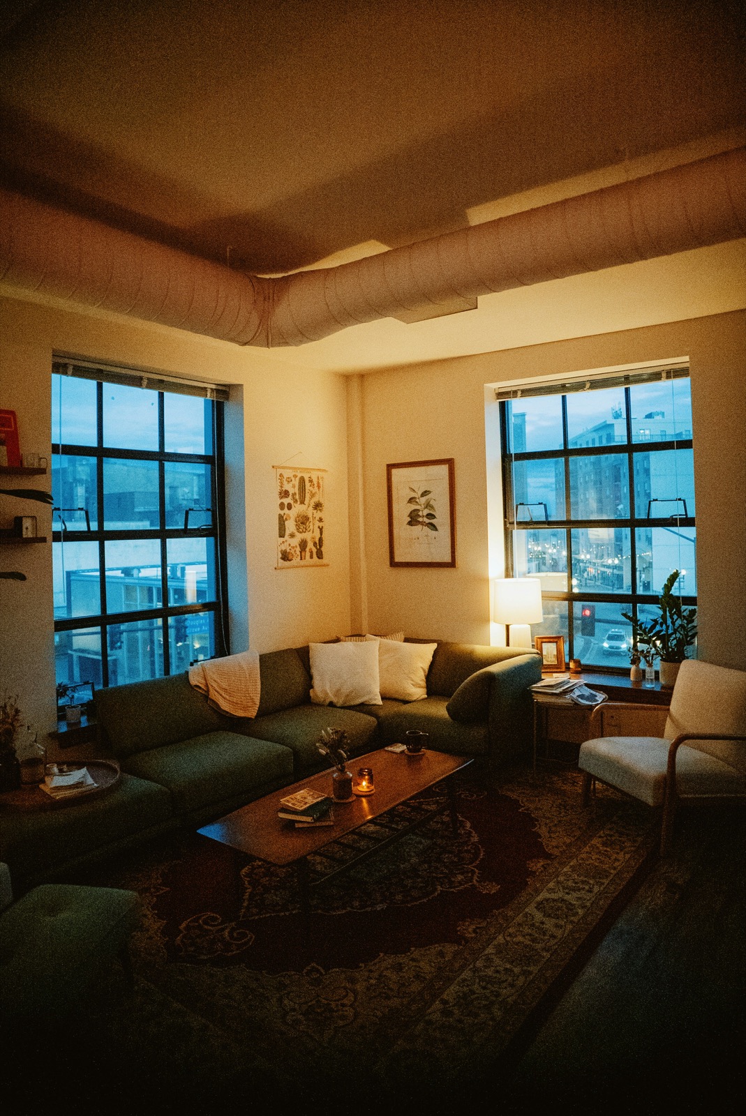 A warm, lived-in sitting room at dusk